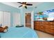 Spacious bedroom with large TV and dresser at 6430 Watercrest Way # 201, Lakewood Ranch, FL 34202