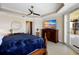 Bedroom with large TV, comfortable seating, and balcony access at 6430 Watercrest Way # 201, Lakewood Ranch, FL 34202