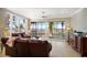 Bright living room with leather sofas and access to a screened balcony at 6430 Watercrest Way # 201, Lakewood Ranch, FL 34202