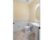 Small bathroom with pedestal sink, toilet and tiled floor at 5654 Simonton St, Bradenton, FL 34203