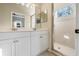 Bathroom with double vanity, shower, and mirror at 5654 Simonton St, Bradenton, FL 34203