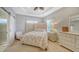 Main bedroom with upholstered headboard and ensuite bathroom at 5654 Simonton St, Bradenton, FL 34203