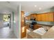 View of kitchen and foyer with tile floors and wood cabinets at 5654 Simonton St, Bradenton, FL 34203