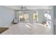 Living room with tiled floors, access to patio and stairs at 5654 Simonton St, Bradenton, FL 34203