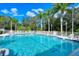 Refreshing community pool with lounge chairs and palm trees at 5654 Simonton St, Bradenton, FL 34203