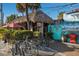 The Cottage Bar, featuring a thatched roof and outdoor seating at 89 Beach Rd # 202 & 203, Sarasota, FL 34242