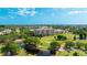 Aerial view of a condominium complex surrounded by a golf course and scenic lakes at 4410 Fairways Blvd # 406, Bradenton, FL 34209