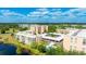 Aerial view of condominium complex featuring beautiful landscaping, a swimming pool, and covered parking at 4410 Fairways Blvd # 406, Bradenton, FL 34209