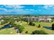 Picturesque aerial view of a condo complex overlooking a verdant golf course and serene ponds at 4410 Fairways Blvd # 406, Bradenton, FL 34209