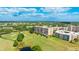 Lovely aerial view showcases a condo building near a golf course with ponds and trees at 4410 Fairways Blvd # 406, Bradenton, FL 34209