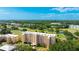 Scenic aerial view of a multi-story condo building situated on a lush green golf course at 4410 Fairways Blvd # 406, Bradenton, FL 34209