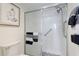 Bathroom featuring a walk-in shower, grab bar, and neutral decor at 4410 Fairways Blvd # 406, Bradenton, FL 34209