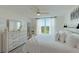Bright bedroom features a comfortable bed, stylish decor, and a picturesque view from the window at 4410 Fairways Blvd # 406, Bradenton, FL 34209
