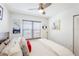 Bedroom featuring a bed with gray headboard, ceiling fan, and window at 4410 Fairways Blvd # 406, Bradenton, FL 34209