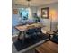 The dining room features a rustic wooden table, modern seating, and an open view to the kitchen at 4410 Fairways Blvd # 406, Bradenton, FL 34209