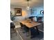 Dining area with a wooden table, seating for four, and modern pendant lighting at 4410 Fairways Blvd # 406, Bradenton, FL 34209