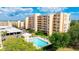 Condo complex featuring a refreshing community swimming pool and meticulously maintained landscaping at 4410 Fairways Blvd # 406, Bradenton, FL 34209