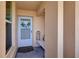 Close-up of a welcoming front door with a wreath and a decorative lantern and bench at 4410 Fairways Blvd # 406, Bradenton, FL 34209