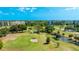 Aerial view of a lush golf course with sand traps, lakes, and condominium buildings at 4410 Fairways Blvd # 406, Bradenton, FL 34209