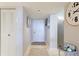 Neutral hallway with a front door, decorative wall art, and easy access to the kitchen at 4410 Fairways Blvd # 406, Bradenton, FL 34209
