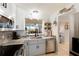 Updated kitchen featuring granite countertops, stainless steel appliances and charming nautical decor at 4410 Fairways Blvd # 406, Bradenton, FL 34209