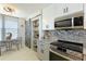 Bright kitchen featuring marble countertops, modern appliances, and a charming barn door pantry at 4410 Fairways Blvd # 406, Bradenton, FL 34209