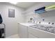 Laundry room featuring a side-by-side washer and dryer and shelving at 4410 Fairways Blvd # 406, Bradenton, FL 34209