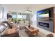 Bright living room with sliding glass doors leading to outdoor views and cozy fireplace at 4410 Fairways Blvd # 406, Bradenton, FL 34209