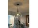 Stylish glass pendant light fixture hangs above a dining area, adding a touch of elegance at 4410 Fairways Blvd # 406, Bradenton, FL 34209