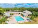 Aerial view of a large community swimming pool with lounge chairs and a hot tub at 4410 Fairways Blvd # 406, Bradenton, FL 34209