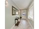 Bright and airy entryway with a large mirror and wood-look tile floors at 2314 Avenue B, Bradenton Beach, FL 34217
