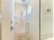 Spa-like shower with patterned walls and pebble floor at 2314 Avenue B, Bradenton Beach, FL 34217
