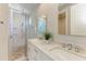 Modern bathroom with double vanity, large shower, and patterned tile at 2314 Avenue B, Bradenton Beach, FL 34217