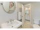 Bathroom with single vanity, toilet, and access to another room at 2314 Avenue B, Bradenton Beach, FL 34217