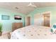 Primary bedroom with a king-size bed, dresser, and a large TV at 2314 Avenue B, Bradenton Beach, FL 34217