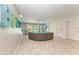 Relaxing living room with a curved sofa, herringbone floors and access to a pool at 2314 Avenue B, Bradenton Beach, FL 34217