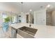 Stylish kitchen with a farmhouse sink, ample counter space and modern light fixtures at 2314 Avenue B, Bradenton Beach, FL 34217