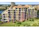 Beautiful aerial view of multi-story condo building with lush landscaping and surrounding neighborhood at 611 Riviera Dunes Way # 108, Palmetto, FL 34221