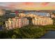 Stunning aerial view of the multi-Gathering dwelling and marina, set against a vibrant sky at 611 Riviera Dunes Way # 108, Palmetto, FL 34221