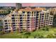 Stunning aerial view of the multi-story complex showcasing red tile roof and lush green landscaping at 611 Riviera Dunes Way # 108, Palmetto, FL 34221
