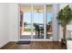 Balcony view through sliding glass doors, showcasing outdoor seating and scenic waterfront views at 611 Riviera Dunes Way # 108, Palmetto, FL 34221