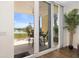 Balcony view through sliding glass doors, showcasing outdoor seating and scenic waterfront views at 611 Riviera Dunes Way # 108, Palmetto, FL 34221
