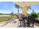Comfortable balcony featuring seating for four with scenic views of lush greenery and serene waterfront at 611 Riviera Dunes Way # 108, Palmetto, FL 34221