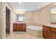 Bright bathroom with a soaking tub and double vanity, providing ample space at 611 Riviera Dunes Way # 108, Palmetto, FL 34221