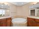 A spacious bathroom featuring a large soaking tub and double sink vanity at 611 Riviera Dunes Way # 108, Palmetto, FL 34221