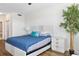 Cozy bedroom with a queen-sized bed, decorative pillows, and a tall indoor plant at 611 Riviera Dunes Way # 108, Palmetto, FL 34221