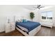 Bright bedroom featuring a queen-sized bed, white furniture, and a view of the water at 611 Riviera Dunes Way # 108, Palmetto, FL 34221