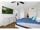 Bedroom featuring a view to another room, with a TV and a ceiling fan at 611 Riviera Dunes Way # 108, Palmetto, FL 34221