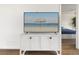 Stylishly furnished bedroom featuring a TV with a beach scene and a view into another room at 611 Riviera Dunes Way # 108, Palmetto, FL 34221