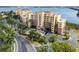 Stunning condominium buildings featuring terracotta roofs, balconies, lush landscaping, and ample parking at 611 Riviera Dunes Way # 108, Palmetto, FL 34221